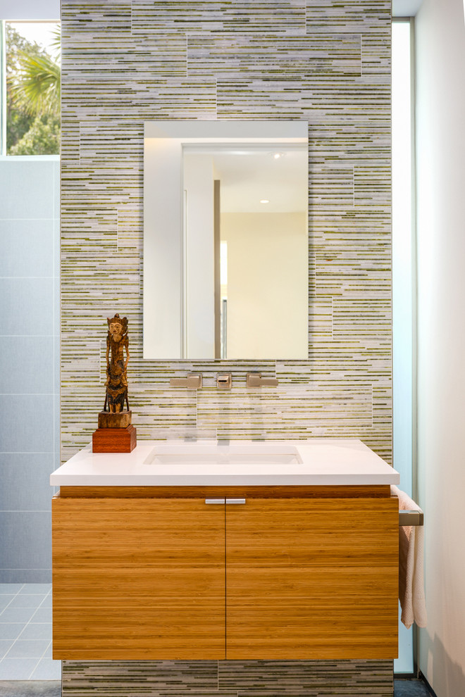 Example of a mid-sized trendy kids' multicolored tile and glass tile concrete floor, gray floor and single-sink bathroom design in Other with flat-panel cabinets, medium tone wood cabinets, white walls, an undermount sink, quartz countertops, white countertops, a wall-mount toilet and a floating vanity