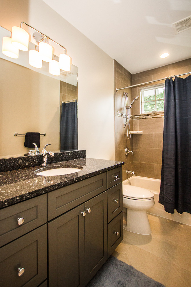 Example of a mid-sized arts and crafts kids' gray tile and ceramic tile ceramic tile bathroom design in DC Metro with an undermount sink, recessed-panel cabinets, black cabinets, granite countertops, a two-piece toilet and gray walls