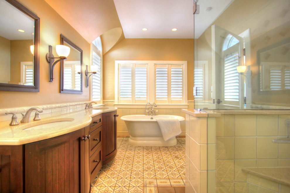 Beach style master gray tile and ceramic tile cement tile floor and yellow floor bathroom photo in New York with beaded inset cabinets, brown cabinets, beige walls, an undermount sink, quartz countertops and a hinged shower door