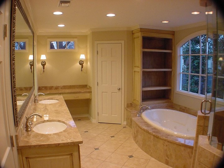 Bathroom - traditional beige tile and stone tile bathroom idea in Dallas with an undermount sink, a two-piece toilet, recessed-panel cabinets, distressed cabinets and beige walls
