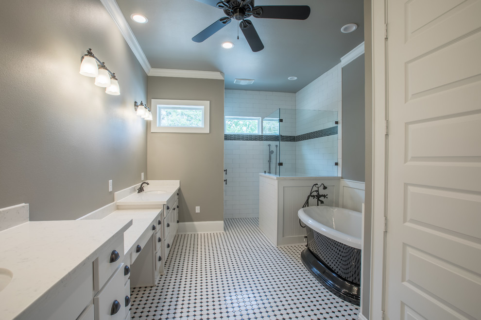 Inspiration for a large classic ensuite bathroom in Houston with flat-panel cabinets, white cabinets, a freestanding bath, a corner shower, white tiles, ceramic tiles, grey walls, ceramic flooring, a submerged sink, granite worktops, white floors, an open shower and white worktops.