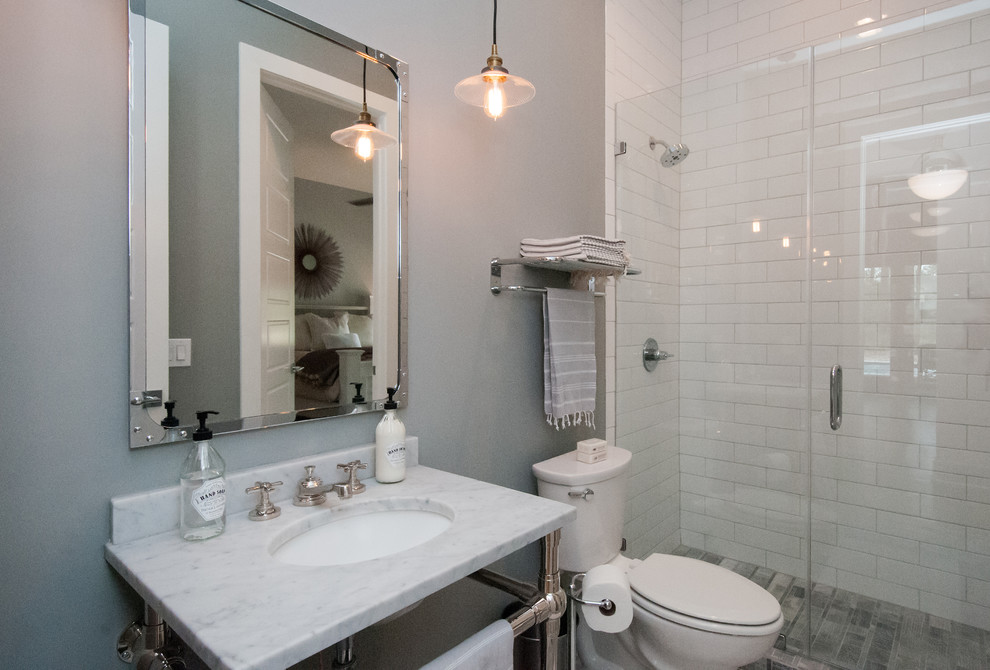 Inspiration for a large classic ensuite bathroom in Houston with an alcove shower, a one-piece toilet, white tiles, cement tiles, grey walls, ceramic flooring, a submerged sink, marble worktops, grey floors and a hinged door.