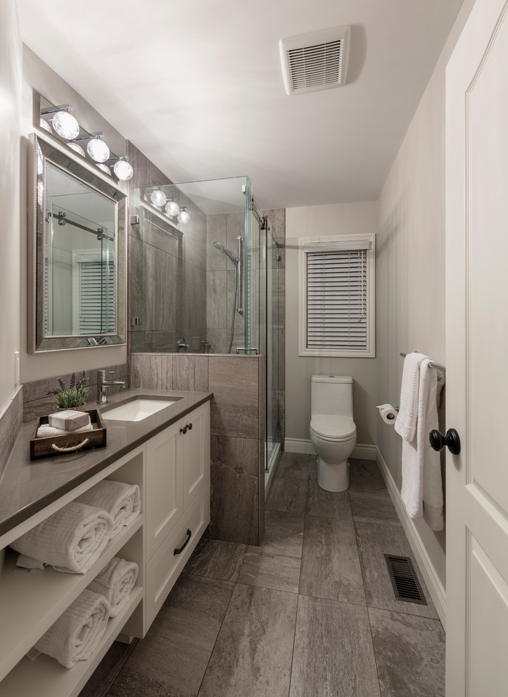 Inspiration for a traditional ensuite bathroom in Vancouver with shaker cabinets, white cabinets, an alcove shower, grey tiles, grey walls, a submerged sink, engineered stone worktops, grey floors and a sliding door.