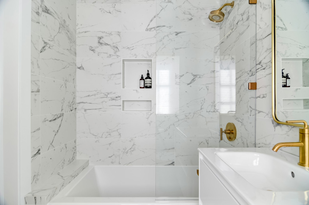 This is an example of a small contemporary ensuite bathroom in Minneapolis with flat-panel cabinets, a built-in bath, a two-piece toilet, porcelain tiles, marble flooring, an integrated sink and an open shower.