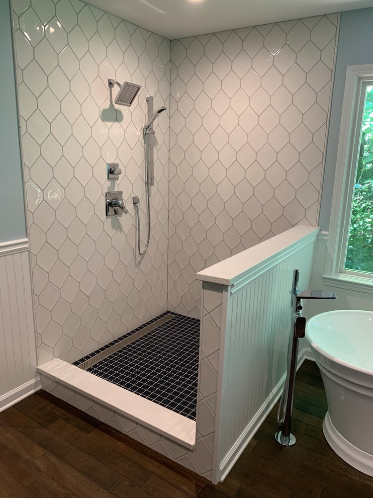 Design ideas for a large traditional ensuite bathroom in Atlanta with recessed-panel cabinets, a freestanding bath, a walk-in shower, blue walls, dark hardwood flooring, a submerged sink, engineered stone worktops, brown floors, an open shower and white worktops.
