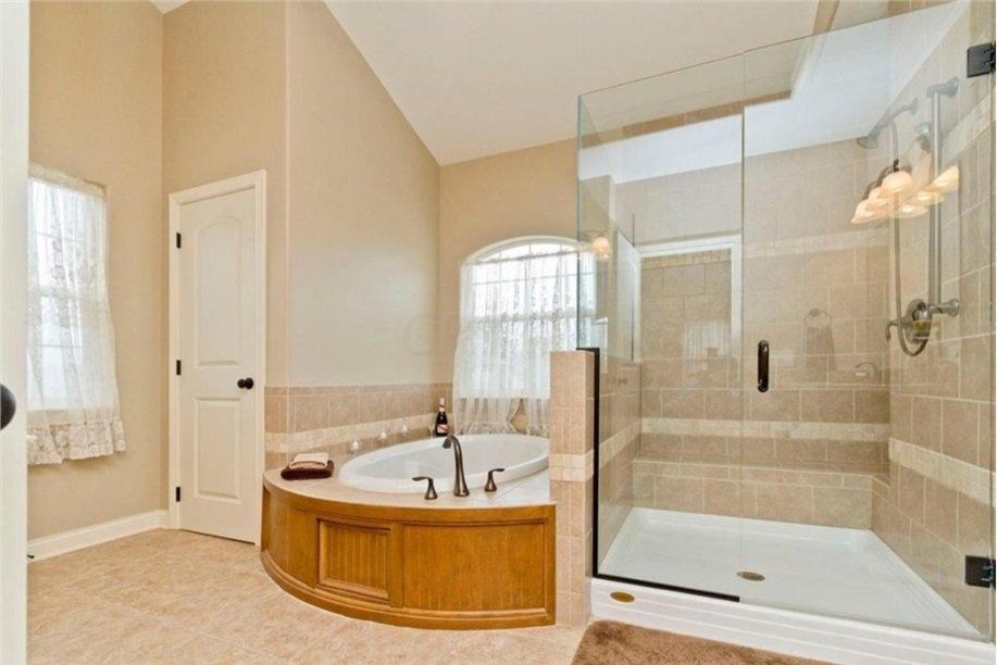 Design ideas for a large traditional ensuite bathroom in Columbus with a submerged sink, recessed-panel cabinets, light wood cabinets, granite worktops, a built-in bath, a walk-in shower, a two-piece toilet, beige tiles, ceramic tiles, beige walls and ceramic flooring.