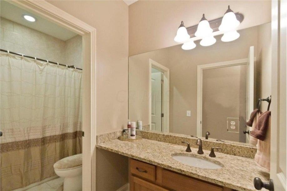Bathroom - large traditional kids' beige tile and ceramic tile ceramic tile bathroom idea in Columbus with an undermount sink, recessed-panel cabinets, light wood cabinets, granite countertops, a two-piece toilet and beige walls