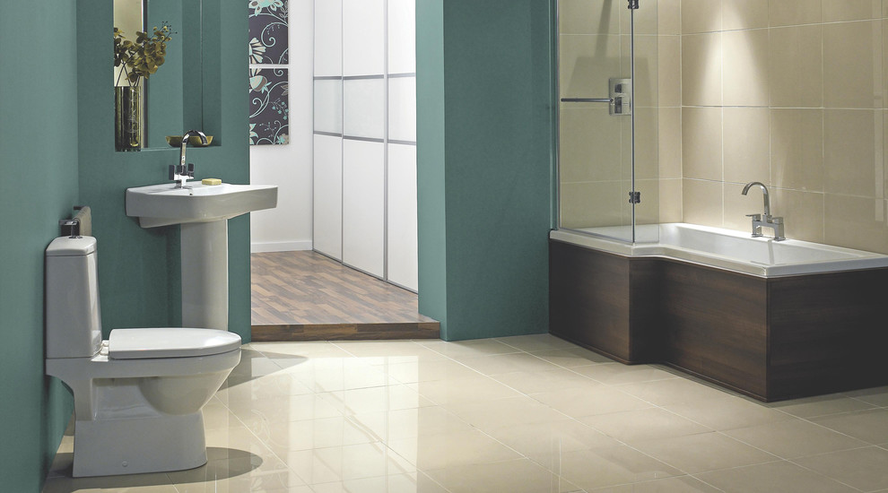 Inspiration for a medium sized contemporary ensuite bathroom in Hampshire with a wall-mounted sink, a built-in bath, a shower/bath combination, a one-piece toilet, beige tiles, blue walls and porcelain flooring.