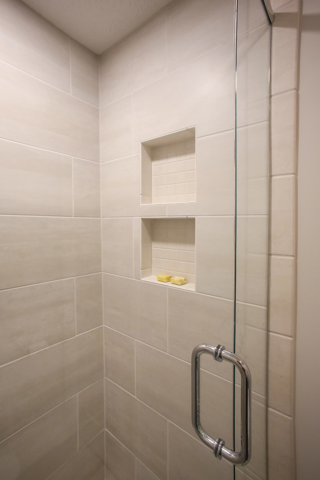 Example of a mid-sized classic master gray tile and ceramic tile porcelain tile and gray floor bathroom design in Atlanta with raised-panel cabinets, gray cabinets, a two-piece toilet, gray walls, an undermount sink, granite countertops, a hinged shower door and multicolored countertops