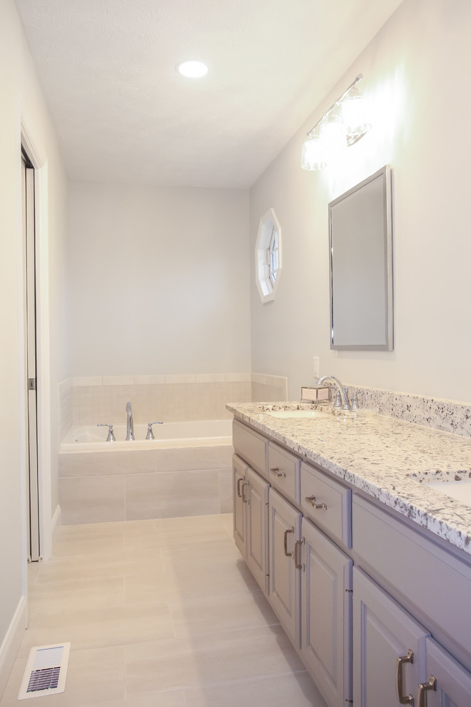 This is an example of a medium sized classic ensuite bathroom in Atlanta with raised-panel cabinets, grey cabinets, an alcove bath, an alcove shower, a two-piece toilet, grey tiles, ceramic tiles, grey walls, porcelain flooring, a submerged sink, granite worktops, grey floors, a hinged door and multi-coloured worktops.