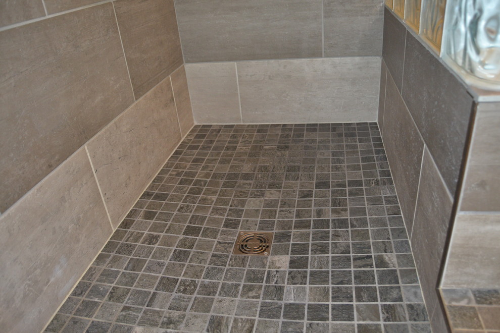 Klassisk inredning av ett mellanstort vit vitt en-suite badrum, med en toalettstol med separat cisternkåpa, grå kakel, vita väggar, grått golv, med dusch som är öppen, luckor med infälld panel, svarta skåp, en öppen dusch, porslinskakel, klinkergolv i porslin, ett integrerad handfat och bänkskiva i akrylsten