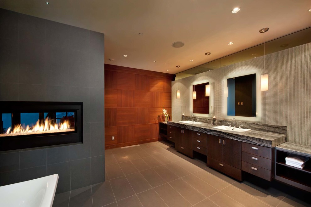 Large contemporary ensuite bathroom in Vancouver with a vessel sink, freestanding cabinets, dark wood cabinets, marble worktops, a hot tub, a built-in shower, a one-piece toilet and stone slabs.