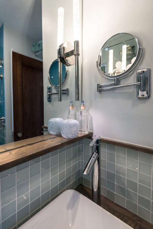 Exemple d'une petite salle de bain principale chic en bois brun avec une vasque, un placard sans porte, un plan de toilette en bois, WC séparés, un carrelage bleu, un carrelage en pâte de verre et un mur bleu.