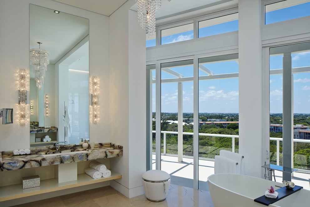 Inspiration for a large contemporary ensuite bathroom in Miami with a submerged sink, open cabinets, light wood cabinets, solid surface worktops, a freestanding bath, an alcove shower, a wall mounted toilet, white tiles, ceramic tiles, white walls and marble flooring.