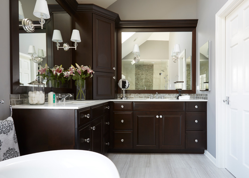 Example of a mid-sized transitional master multicolored tile and glass tile porcelain tile bathroom design in Chicago with raised-panel cabinets, dark wood cabinets, gray walls, an undermount sink and quartz countertops