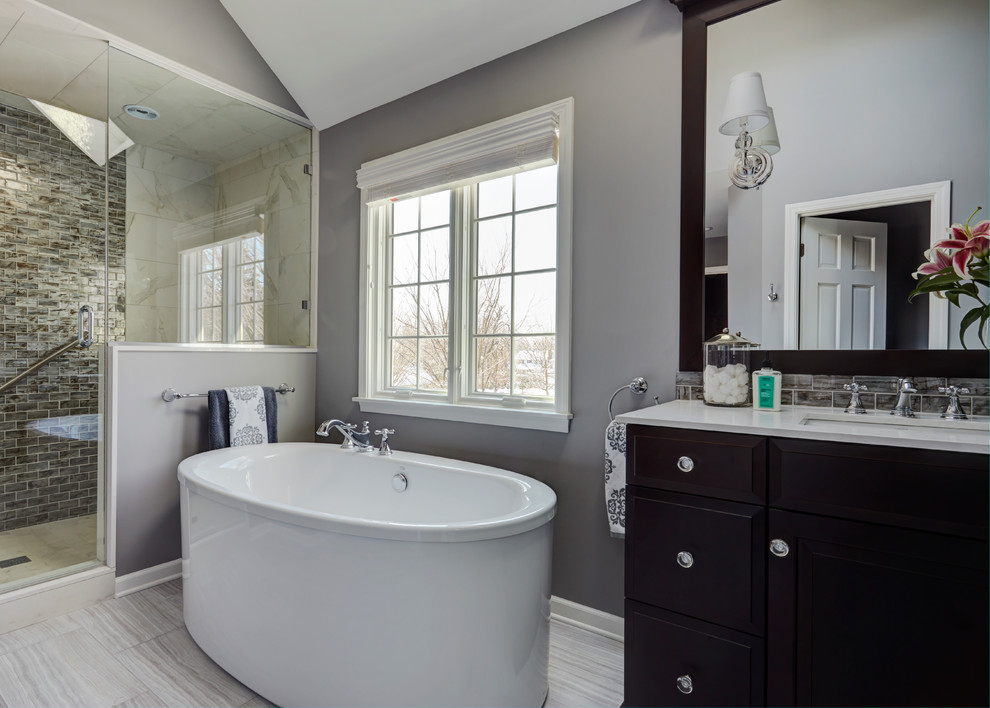 Mid-sized transitional master multicolored tile and glass tile porcelain tile bathroom photo in Chicago with raised-panel cabinets, dark wood cabinets, an undermount sink, gray walls and quartz countertops