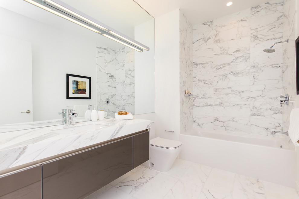 Bathroom - mid-sized contemporary 3/4 marble floor bathroom idea in San Francisco with a wall-mount toilet, white walls and marble countertops