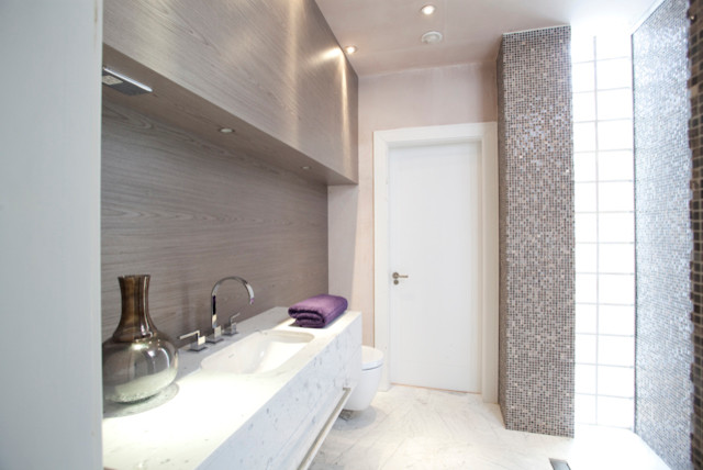 Photo of a medium sized contemporary ensuite bathroom in London with a trough sink, freestanding cabinets, dark wood cabinets, solid surface worktops, a freestanding bath, a built-in shower, white tiles, ceramic tiles, white walls and ceramic flooring.