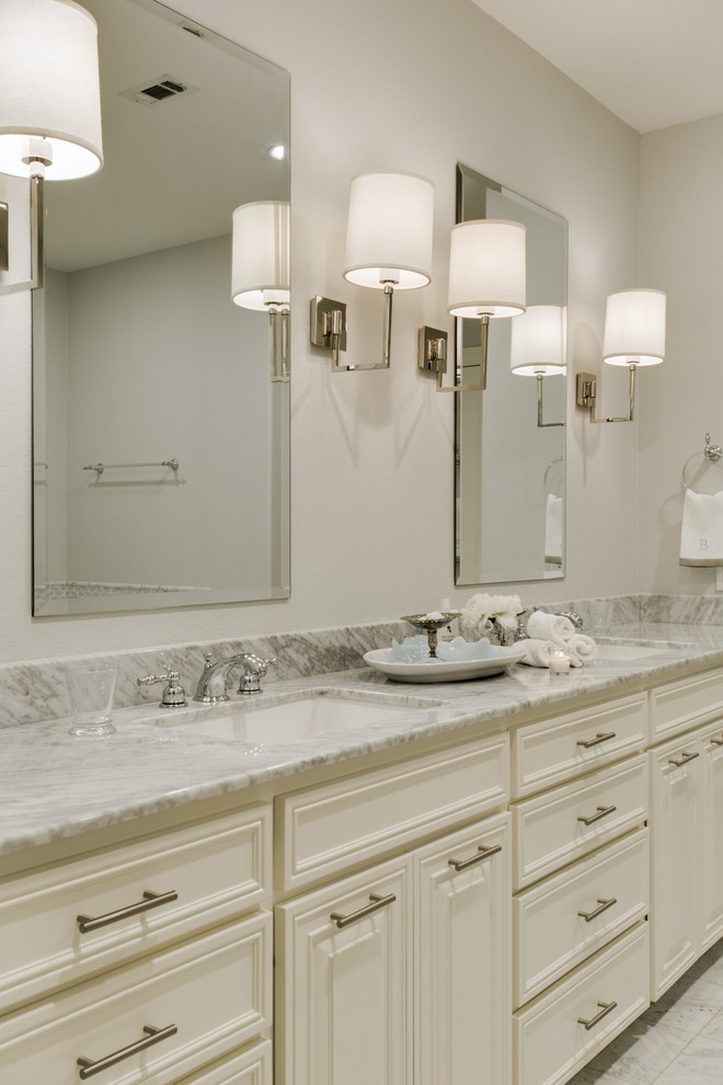 Example of a large transitional master gray tile and mosaic tile marble floor bathroom design in Dallas with an undermount sink, raised-panel cabinets, white cabinets, marble countertops, an undermount tub, a one-piece toilet and gray walls