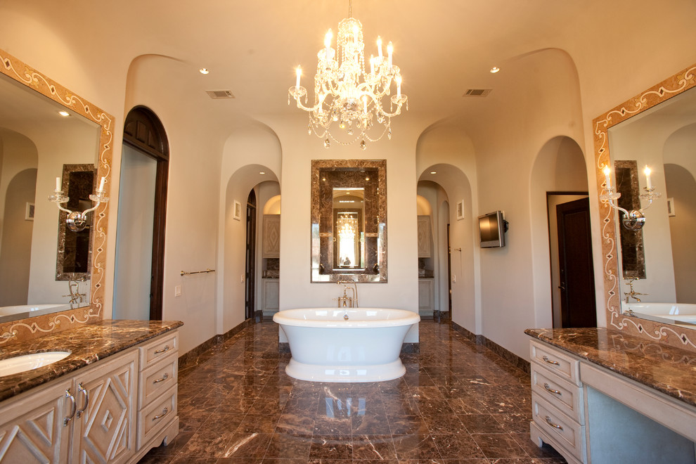 Example of a huge tuscan master brown tile and stone tile marble floor bathroom design in Houston with a drop-in sink, furniture-like cabinets, beige cabinets, marble countertops, a two-piece toilet and beige walls