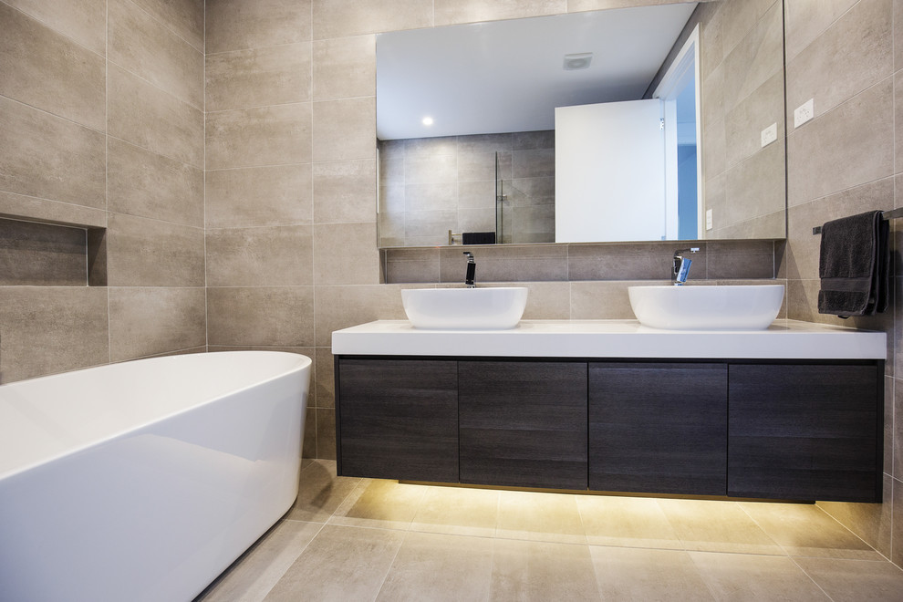 Design ideas for a small modern shower room bathroom in Sydney with flat-panel cabinets, dark wood cabinets, a freestanding bath, grey tiles, ceramic tiles, beige walls, ceramic flooring, engineered stone worktops and beige floors.
