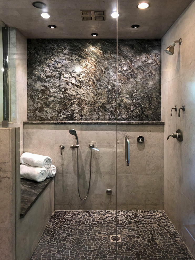 Inspiration for a large traditional ensuite bathroom in Los Angeles with raised-panel cabinets, black cabinets, a walk-in shower, a two-piece toilet, grey tiles, glass tiles, beige walls, pebble tile flooring, a submerged sink, marble worktops, grey floors, an open shower and grey worktops.