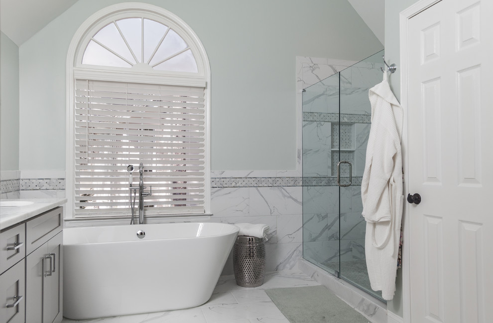 Свежая идея для дизайна: большая главная ванная комната в стиле неоклассика (современная классика) с фасадами в стиле шейкер, серыми фасадами, отдельно стоящей ванной, двойным душем, раздельным унитазом, белой плиткой, мраморной плиткой, зелеными стенами, мраморным полом, врезной раковиной, столешницей из кварцита, белым полом, душем с распашными дверями и белой столешницей - отличное фото интерьера