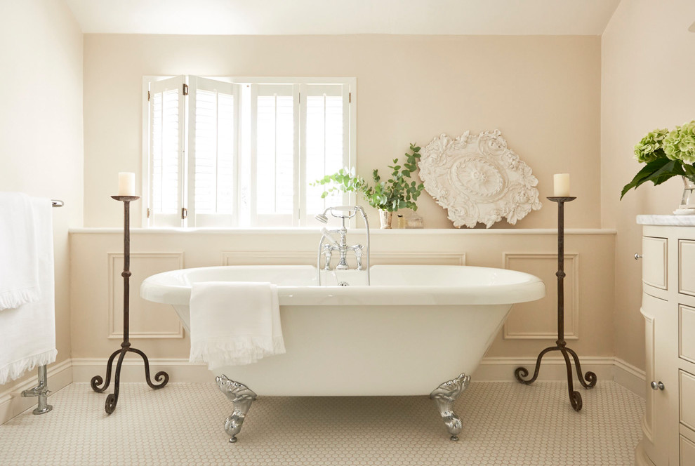 Inspiration for a medium sized classic bathroom in Hertfordshire with beige cabinets, a claw-foot bath, a one-piece toilet, beige walls, ceramic flooring, marble worktops, white floors, white worktops and beaded cabinets.