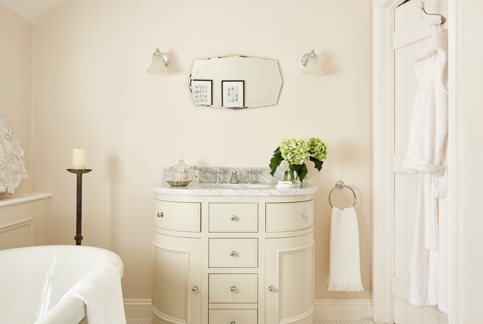 Example of a mid-sized classic kids' white tile and ceramic tile ceramic tile and white floor bathroom design in Hertfordshire with furniture-like cabinets, beige cabinets, a one-piece toilet, beige walls, a console sink and marble countertops