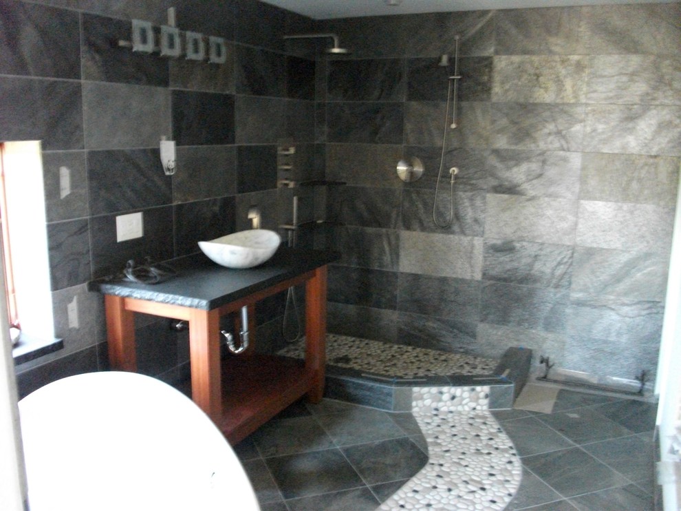 Example of a mid-sized trendy master gray tile and slate tile slate floor and gray floor bathroom design in San Diego with open cabinets, medium tone wood cabinets, gray walls, a vessel sink and soapstone countertops