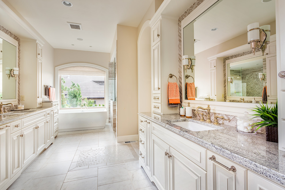 This is an example of a traditional ensuite bathroom in Other with a submerged sink, beaded cabinets, beige cabinets, a built-in bath, an alcove shower, beige walls, porcelain flooring, granite worktops and white floors.
