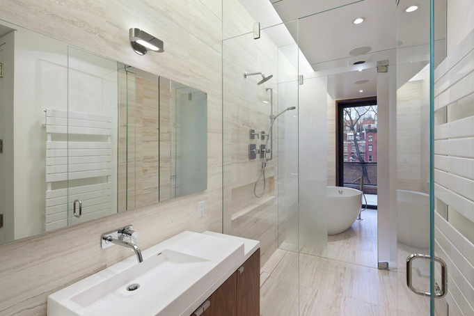 Photo of a contemporary ensuite bathroom in New York with a claw-foot bath, a walk-in shower and a bidet.