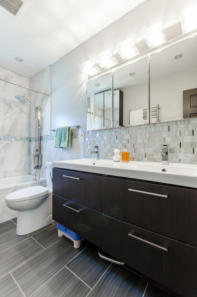 Exempel på ett mellanstort klassiskt en-suite badrum, med släta luckor, svarta skåp, ett badkar i en alkov, en dusch/badkar-kombination, en toalettstol med hel cisternkåpa, blå kakel, grå kakel, vit kakel, mosaik, blå väggar, laminatgolv, ett integrerad handfat, grått golv och dusch med duschdraperi