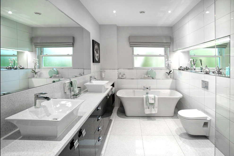 Design ideas for a large contemporary family bathroom in Other with flat-panel cabinets, grey cabinets, a freestanding bath, a walk-in shower, a wall mounted toilet, white tiles, porcelain tiles, grey walls, quartz worktops, white floors, an open shower and white worktops.