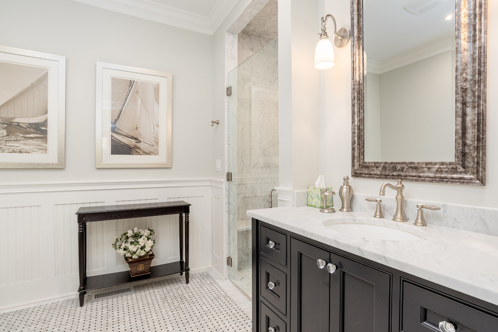 Huge beach style master porcelain tile and white floor double shower photo in Bridgeport with recessed-panel cabinets, black cabinets, beige walls, marble countertops, a hinged shower door and white countertops
