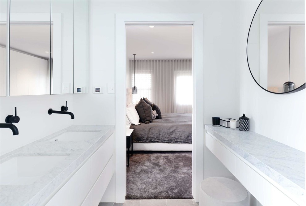 Medium sized contemporary shower room bathroom in Sydney with flat-panel cabinets, white cabinets, white tiles, ceramic tiles, white walls, ceramic flooring, a wall-mounted sink, solid surface worktops, grey floors, an open shower and white worktops.