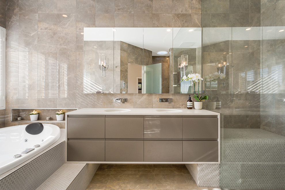 Идея дизайна: главная ванная комната в современном стиле с плоскими фасадами, серыми фасадами, накладной ванной, серой плиткой, плиткой из листового камня, серыми стенами, врезной раковиной, серым полом, белой столешницей, тумбой под две раковины и зеркалом с подсветкой
