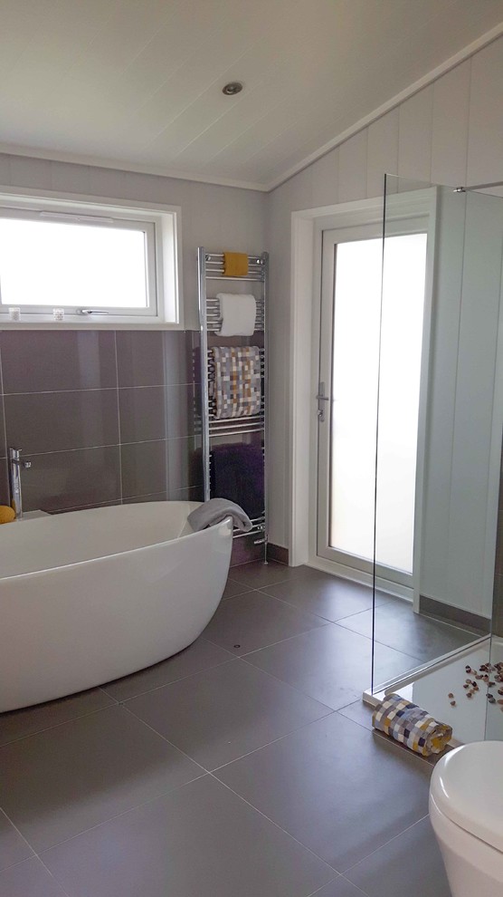 Medium sized contemporary bathroom in London with grey tiles, porcelain tiles, grey walls and porcelain flooring.