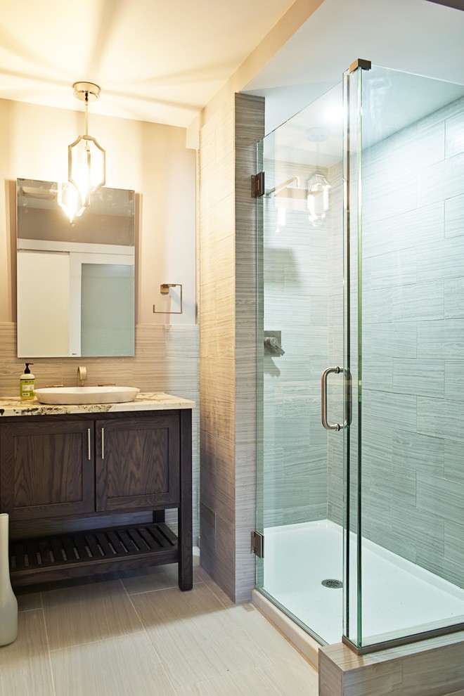 Inspiration for a mid-sized transitional 3/4 gray tile and porcelain tile porcelain tile doorless shower remodel in Chicago with recessed-panel cabinets, dark wood cabinets, a one-piece toilet, gray walls, a vessel sink and quartzite countertops