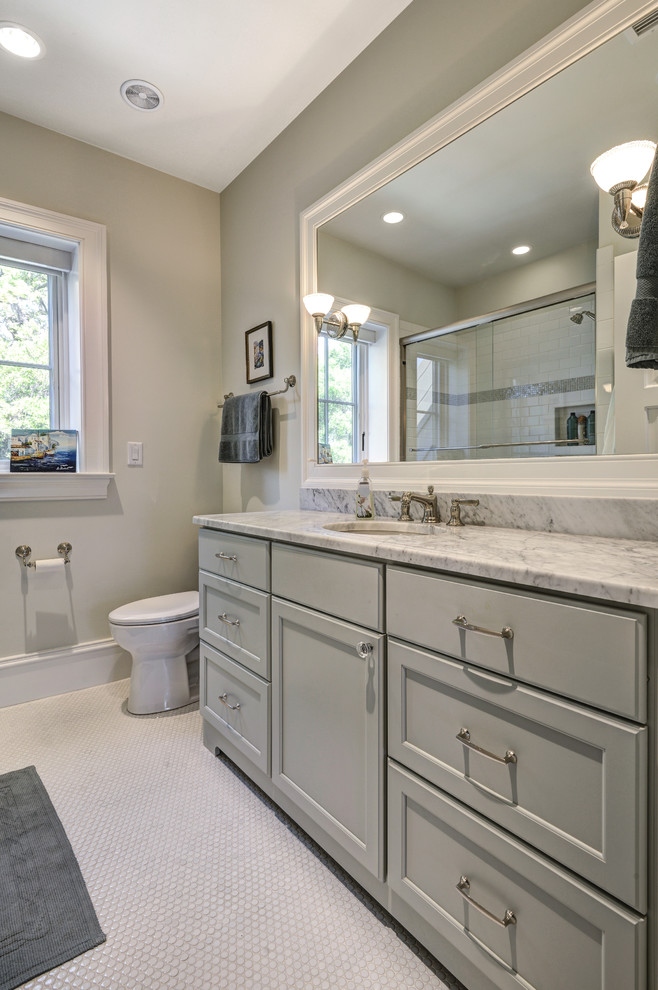 This is an example of a large classic family bathroom in Charleston with a submerged sink, distressed cabinets, marble worktops, an alcove shower, beige tiles, stone tiles, beige walls and beaded cabinets.