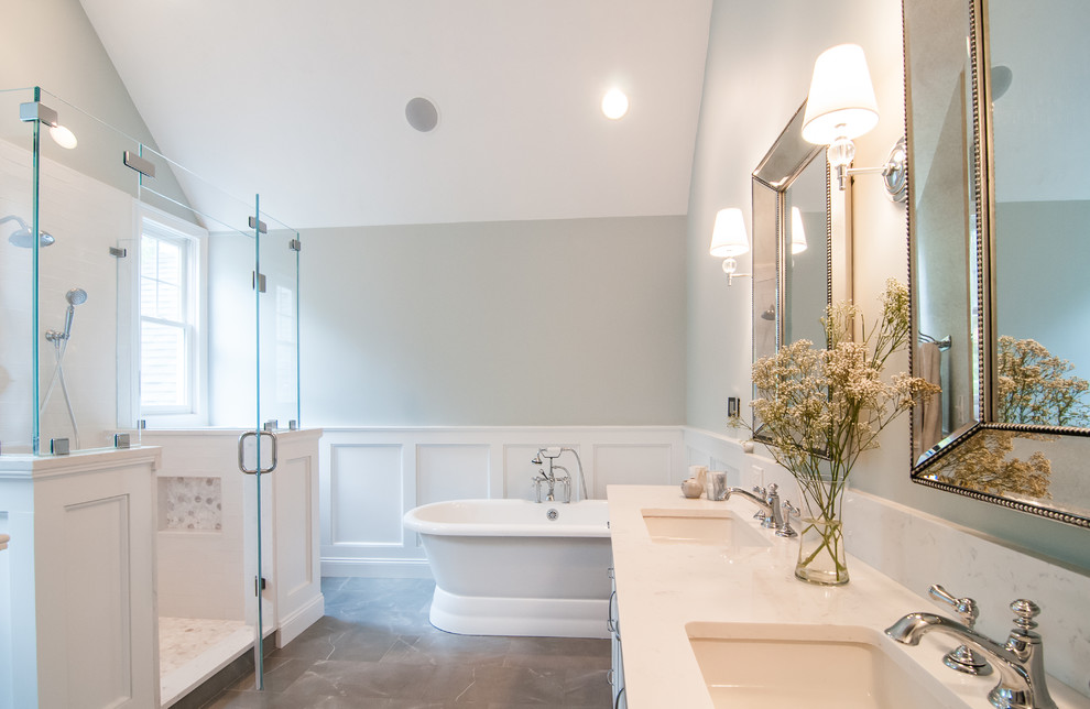 Inspiration for a large transitional master porcelain tile ceramic tile and gray floor bathroom remodel in Boston with recessed-panel cabinets, white cabinets, a two-piece toilet, gray walls, an undermount sink, quartz countertops and a hinged shower door