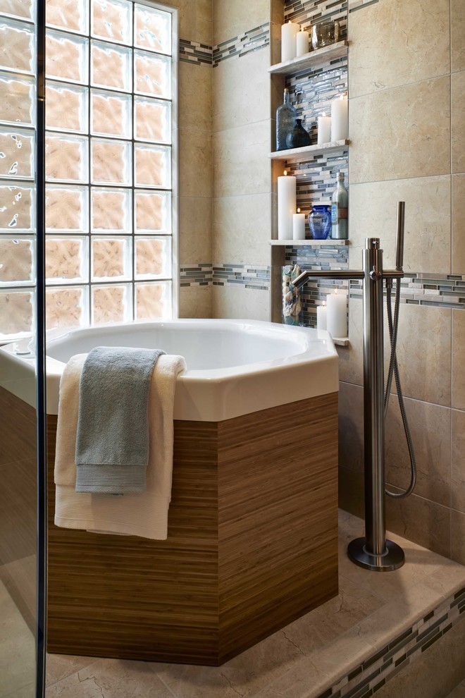 Example of a large trendy master beige tile and porcelain tile porcelain tile bathroom design in Denver with flat-panel cabinets, medium tone wood cabinets, a one-piece toilet, gray walls, an undermount sink and limestone countertops