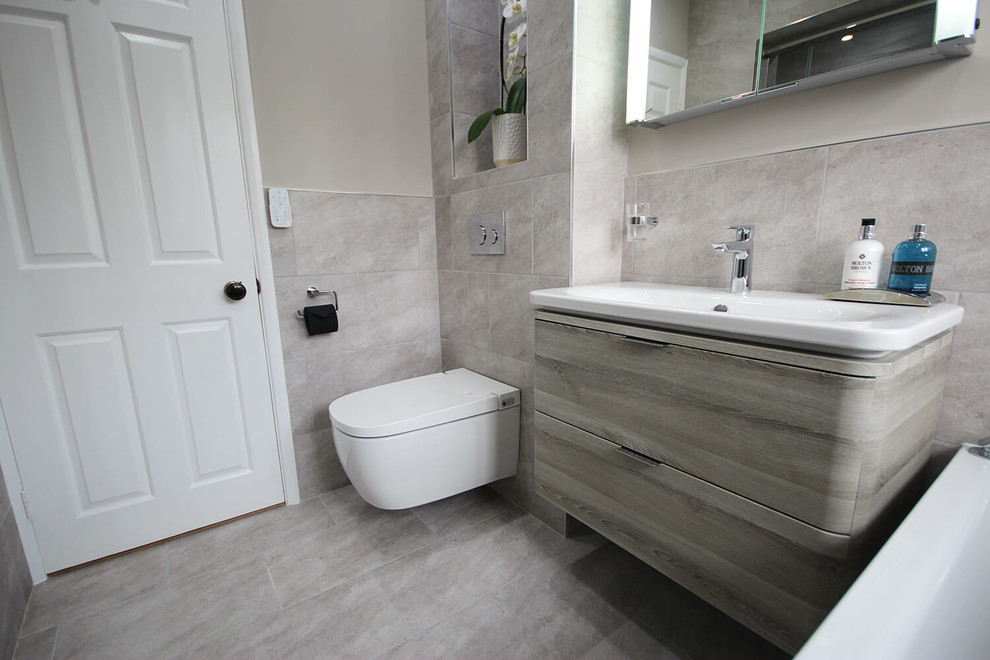 Bathroom - mid-sized contemporary master gray tile and porcelain tile porcelain tile and gray floor bathroom idea in Surrey with a wall-mount toilet, gray walls, an undermount sink and a hinged shower door
