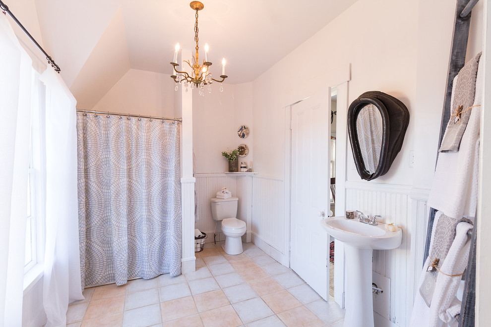 Design ideas for a medium sized country ensuite bathroom in Other with white cabinets, an alcove bath, an alcove shower, a two-piece toilet, white walls, porcelain flooring, a pedestal sink, grey floors, a shower curtain and white worktops.