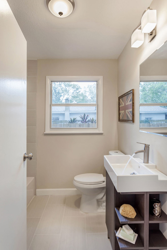 Inspiration for a mid-sized 1950s kids' multicolored tile and stone tile porcelain tile tub/shower combo remodel in Tampa with a trough sink, open cabinets, dark wood cabinets, solid surface countertops, a one-piece toilet and beige walls