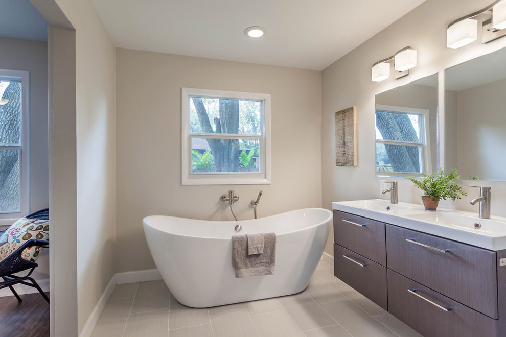 Example of a large 1960s master multicolored tile and stone tile porcelain tile bathroom design in Tampa with a trough sink, flat-panel cabinets, dark wood cabinets, solid surface countertops, a one-piece toilet and beige walls