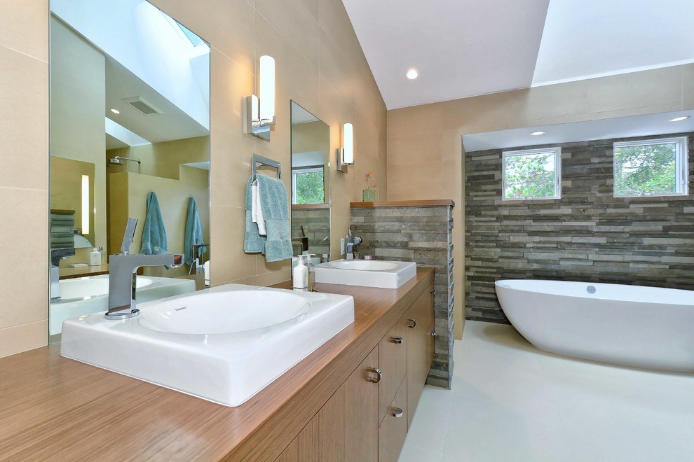 Bathroom - mid-sized contemporary master beige tile and ceramic tile porcelain tile and beige floor bathroom idea in Other with furniture-like cabinets, medium tone wood cabinets, wood countertops, a bidet and a drop-in sink