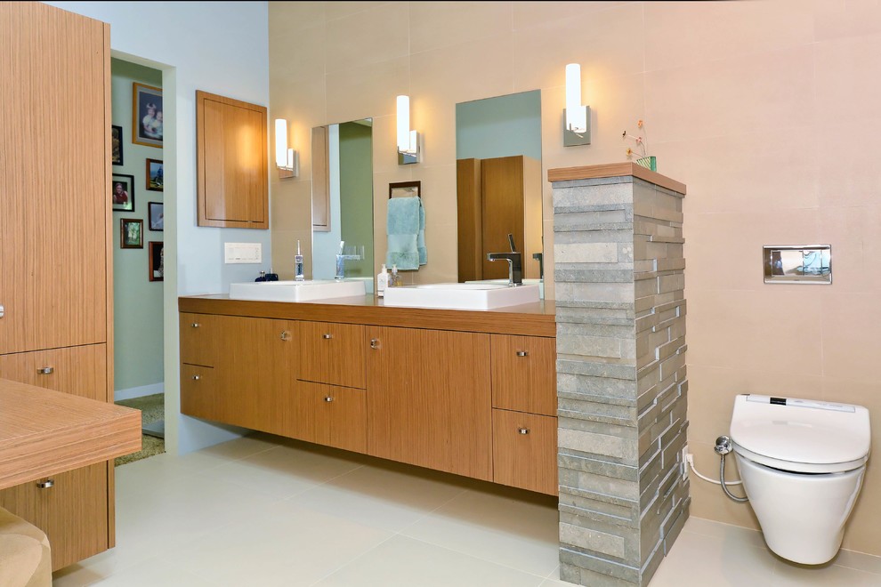 Example of a mid-sized trendy master beige tile and porcelain tile porcelain tile and beige floor bathroom design in Other with furniture-like cabinets, medium tone wood cabinets and a bidet