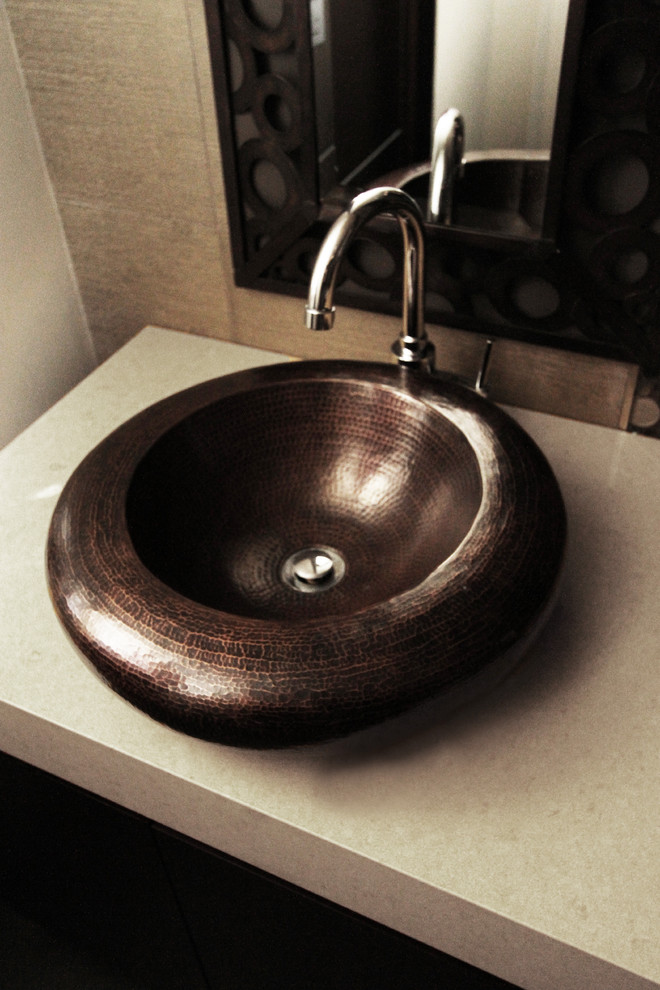 Example of an asian porcelain tile porcelain tile bathroom design in Orange County with a vessel sink and beige walls