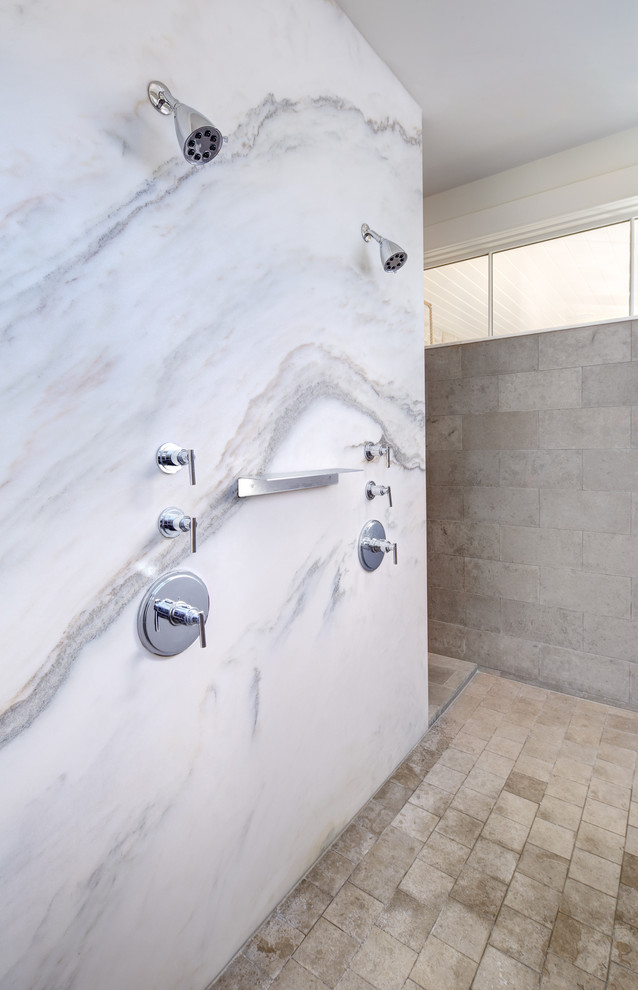 This is an example of a large modern ensuite bathroom in Austin with a submerged sink, flat-panel cabinets, light wood cabinets, marble worktops, a freestanding bath, a walk-in shower, a one-piece toilet, grey tiles, stone tiles, white walls and limestone flooring.